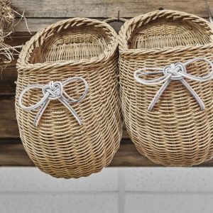 Two withe woven planters hanging on wooden boards as handmade rustic decor. Handmade concept